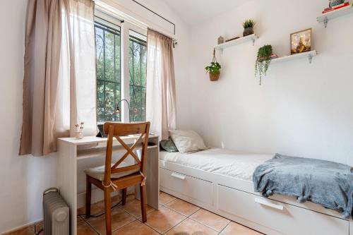 a bedroom with a bed and a chair and a window at Valle de los sueños in Canyelles