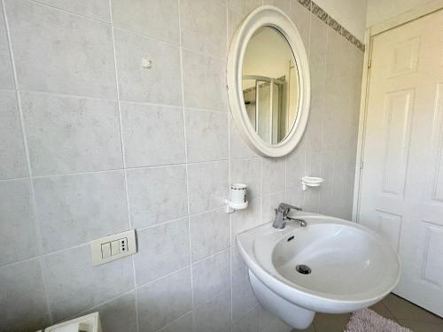 a bathroom with a sink and a mirror at Villetta My Sea in Spotorno