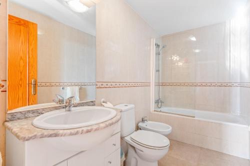 a bathroom with a sink and a toilet and a tub at Apartment in Bolnuevo in Bolnuevo