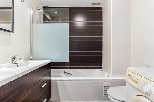 a bathroom with a tub and a sink and a toilet at Sea View near La Cala & Marbella in Mijas Costa