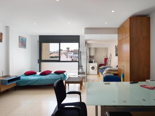 ein Wohnzimmer mit zwei Betten und einem Tisch in der Unterkunft Gesmark in Mataró