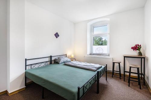 a bedroom with a bed in a white room at Haus Wipperblick in Osmarsleben