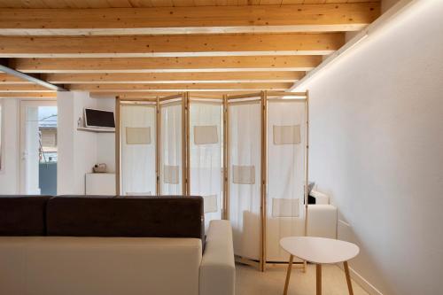 a living room with a couch and a table at Maison Millet Ozein in Aymavilles