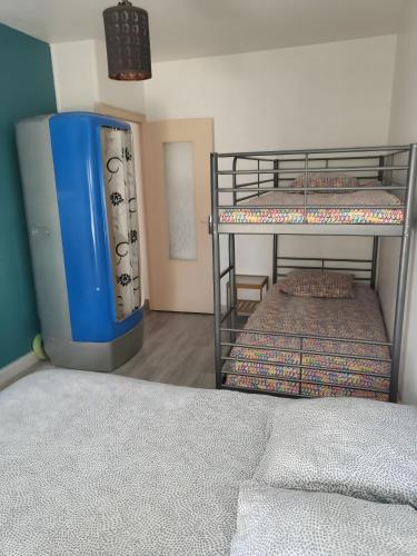 a room with two bunk beds and a blue container at La Maison Defanny - 1 in Muides-sur-Loire
