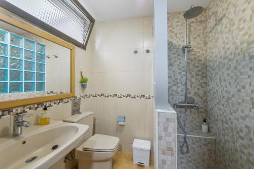 a bathroom with a toilet and a sink and a shower at Casa Carolina Y Roger Tazacorte in Tazacorte