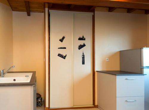 a cabinet with shoes on it in a kitchen at Gîte Télégraphe, Sonnay in Sonnay