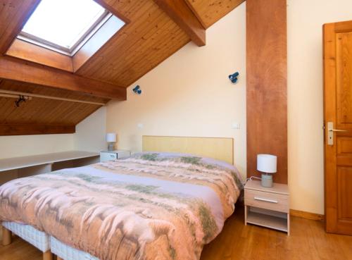 a bedroom with a large bed and a window at Gîte Télégraphe, Sonnay in Sonnay