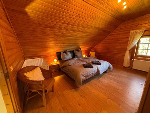 a bedroom with a bed in a wooden cabin at Chalet am Silbersee in Frielendorf