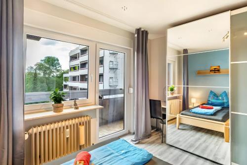 a small room with a bed and a window at Ferienwohnung Goldstadtblick in Pforzheim