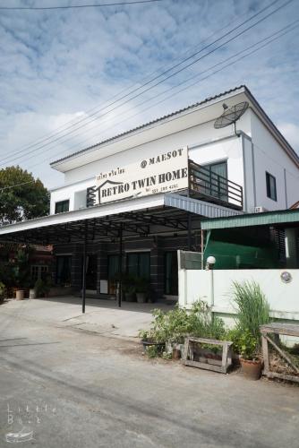a white building with a sign that reads third view home at Retro Twin Home @Maesot in Mae Sot