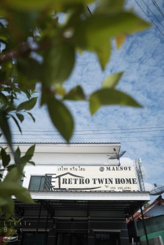 a sign on the top of a building at Retro Twin Home @Maesot in Mae Sot