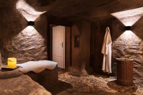a bathroom with a candle and a stone wall at Ferienhaus Lilace in Böttingen
