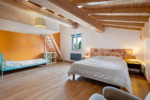 a bedroom with a large bed and a staircase at Chalet Aussois Lerovi in Aussois