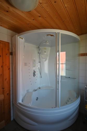 a shower with a glass door in a bathroom at Haus Boddenperle in Breege