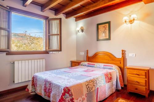 a bedroom with a bed and a window at Casa Collado Santo Tomás in El Collado
