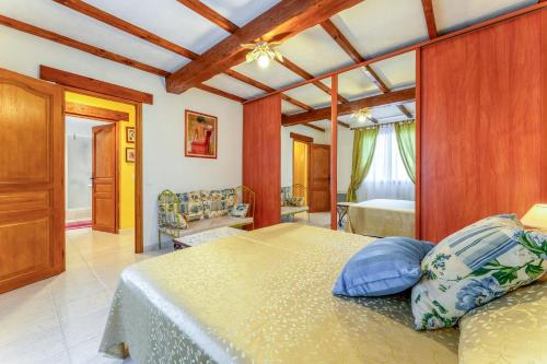 a bedroom with a large bed with blue pillows at Gîte Le Séguret in Entrechaux