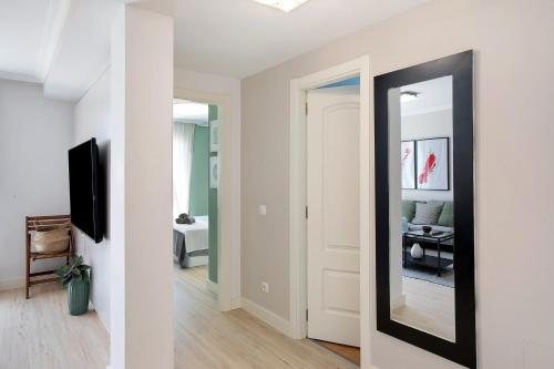 a hallway with a mirror and a living room at Costa Bella la Tejita in La Tejita