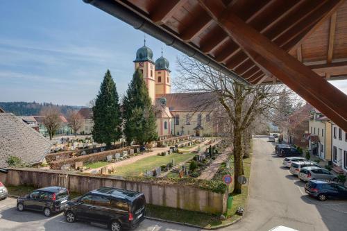 a view of a town with cars parked on a street at Ferienwohnung Christa in Sankt Märgen