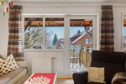 a living room with a view of a balcony at Ferienwohnung Christa in Sankt Märgen