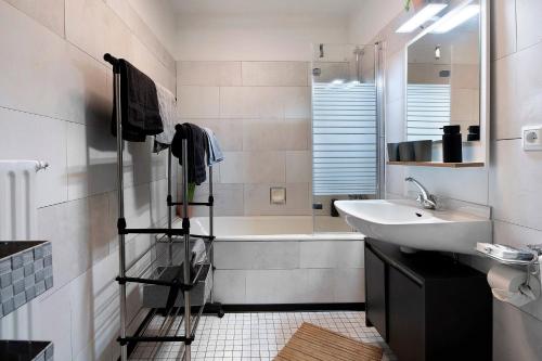 a bathroom with a sink and a bath tub at Blackforest Perla in Höchenschwand