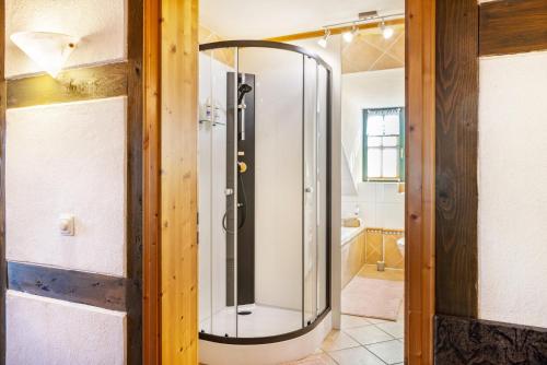 a shower with a glass door in a bathroom at Dachwohnung Im Landhausstil in Meiningen