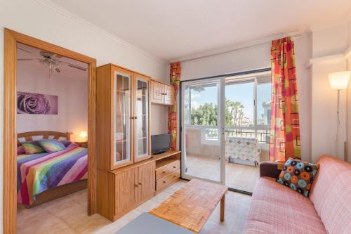 a bedroom with a bed and a sliding glass door at Casa Pepe in Los Narejos