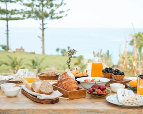 a table topped with bread and fruit and juice at La Meridiana in Capo Vaticano