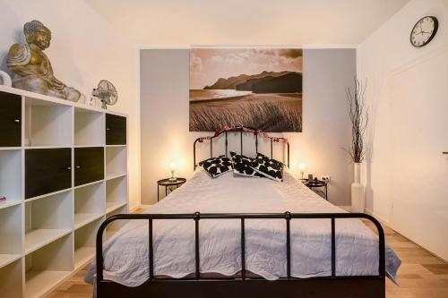 a bedroom with a bed and a painting on the wall at Ferienwohnung Bettersleepat8 in Limburg an der Lahn