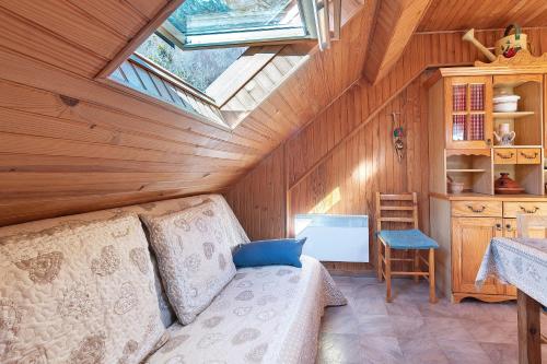 an attic room with a couch and a skylight at Gite Campbieil - Gavarnie in Gèdre