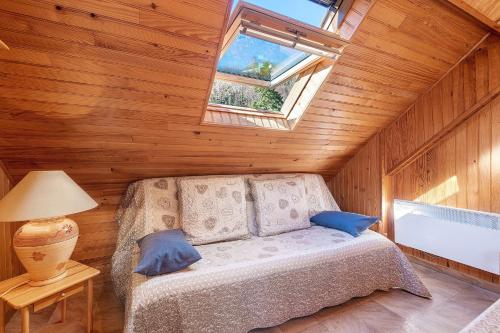 a bedroom with a bed in a room with a window at Gite Campbieil - Gavarnie in Gèdre