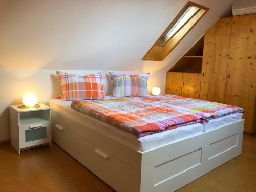 a bedroom with a bed with two lamps on it at Faißbauernhof in Winden im Elztal