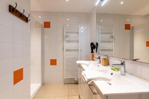 a bathroom with three sinks and two mirrors at Chalet Sambuy - Val de Tamié in Faverges