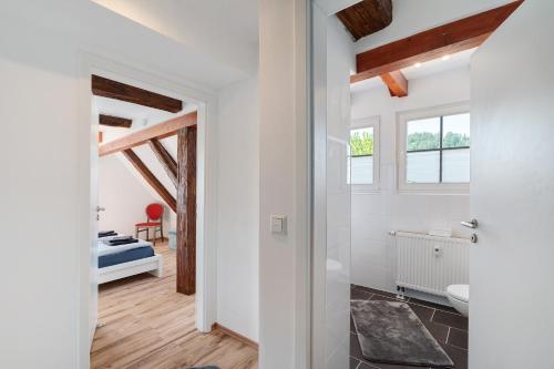 a room with white walls and wooden beams at Vogtshaus de Luxe in Gernsbach