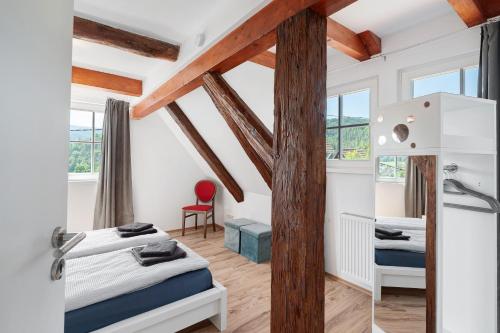 a bedroom with two beds and a desk at Vogtshaus de Luxe in Gernsbach