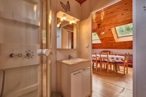 a bathroom with a sink and a dining room at Gite des Granges in Tréminis
