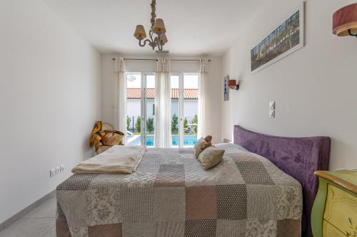 a bedroom with a bed with a teddy bear on it at Villa du Lac - Gastes in Gastes