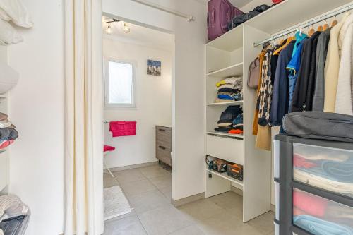 a walk in closet with white walls and shelves at Villa du Lac - Gastes in Gastes