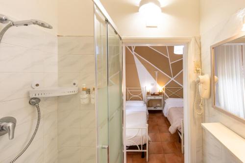 a bathroom with a shower and two beds at Piccolo Paradiso - Montenero in Montenero
