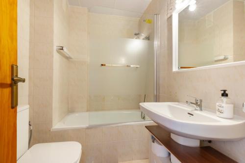 a bathroom with a sink and a tub and a toilet at Moreras in Puerto de Mazarrón