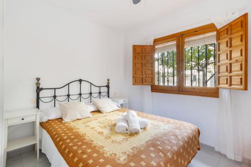 a bedroom with a bed with two towels on it at Moreras in Puerto de Mazarrón