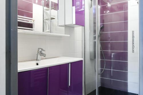 a bathroom with purple cabinets and a shower at T2 Le Panorama in Cassis