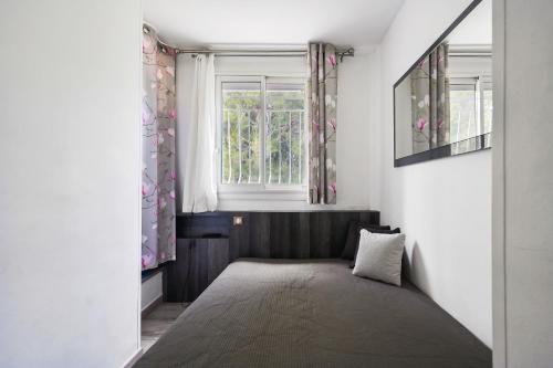 a small room with a window and a bed at T2 Le Panorama in Cassis