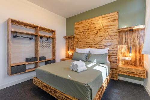 a bedroom with a bed with two towels on it at Terra Nova Penthouse in Lajita