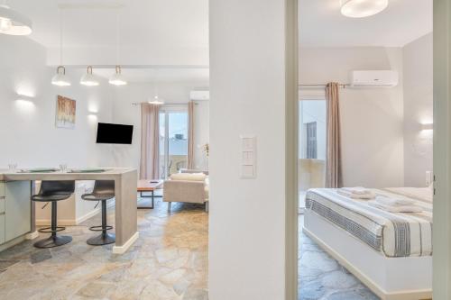 a room with a bed and a desk and a table at Ariston House in Porto Heli