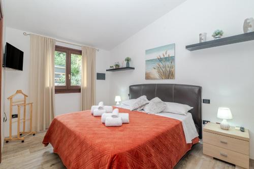 a bedroom with a large bed with a red blanket at Attico Stella Maris in Palau
