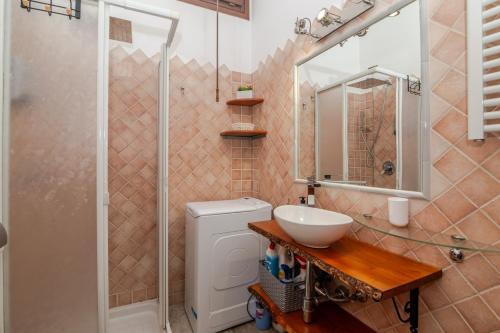 a bathroom with a toilet and a sink and a shower at Attico Stella Maris in Palau