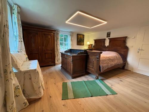 a bedroom with a bed and a desk in a room at Lorenzfranzl in Sankt Oswald ob Eibiswald