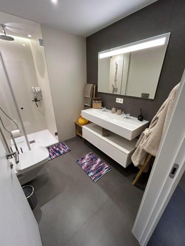 a bathroom with a white sink and a mirror at Blue infinity 7 in Cumbre del Sol