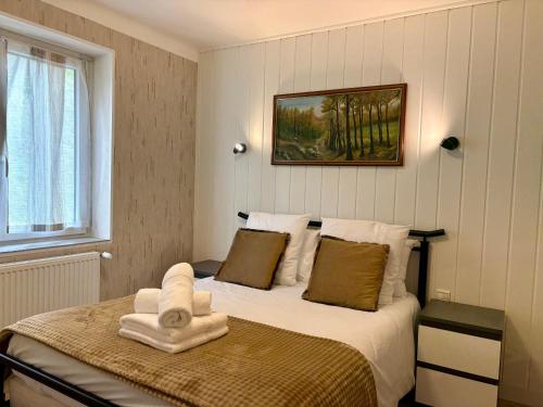 a bedroom with a bed with a towel on it at Maison Des 3 Vallées - Wifi Véranda in Montmélian