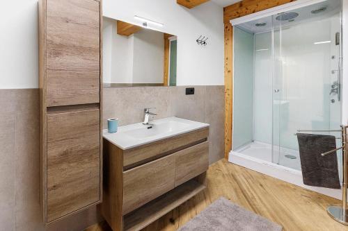 a bathroom with a sink and a shower at Appartamento Via Livigno in Isolaccia